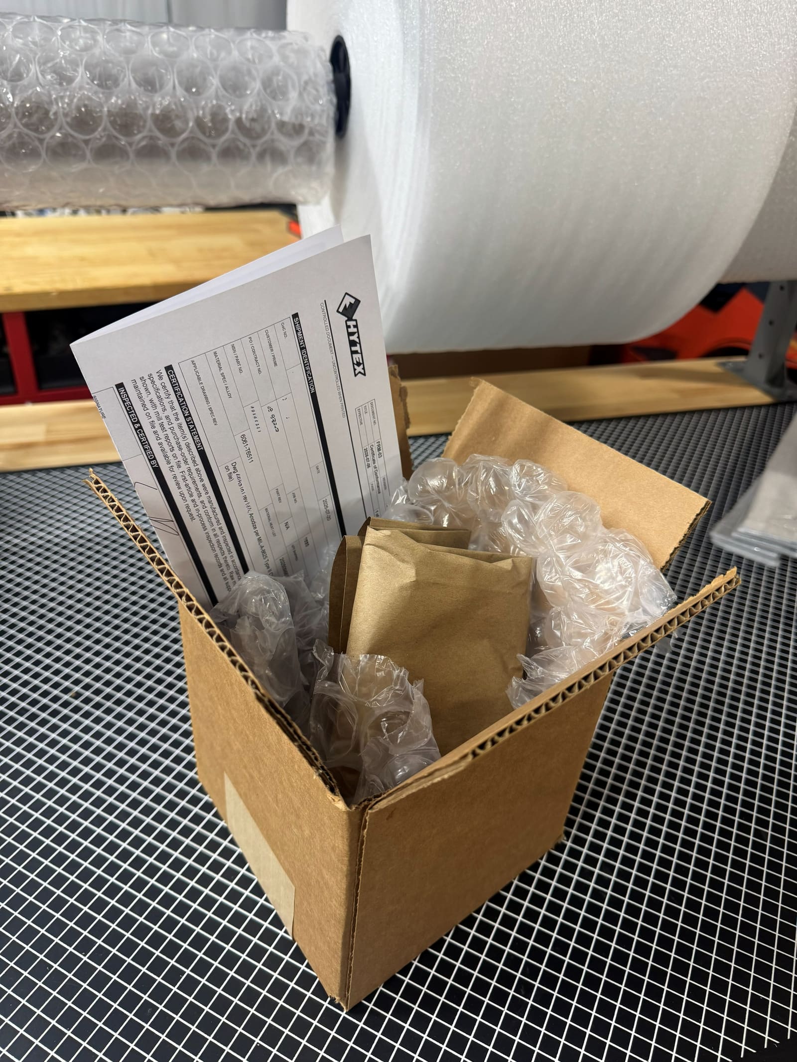 Finished parts packed in a box with inspection paperwork